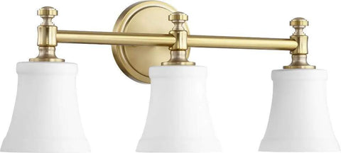 Transitional Three Light Vanity Light From Rossington Collection In Aged Brass Finish With Satin Opal Glass Damp Rated For Bathrooms