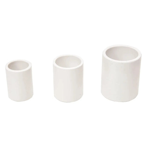 5 Pack One Point Five Inch PVC Pipe Coupling Adapters For Joining Two Pipes Of The Same Diameter Socket End Fittings Lightweight Non Toxic Easy To Install Requires Primer And Cement Perfect For DIY Home Plumbing Hacks. White PVC coupling adapters in three sizes