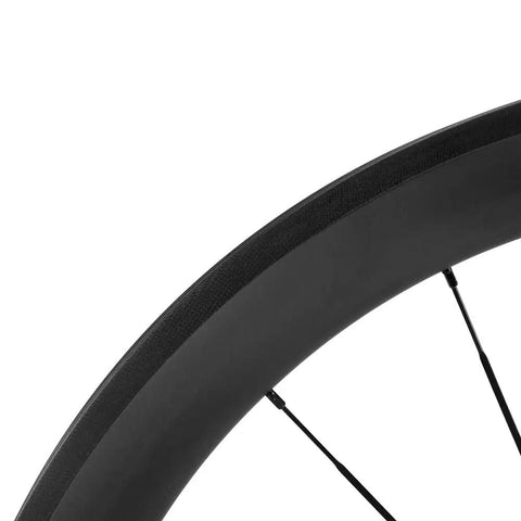 Close-up of 700C Carbon Wheelset With 45mm Deep Rim For Road Bikes, showcasing rim design and material.