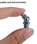 Close-up of hand holding M8x1 25 Grease Nipple Fittings 45 Degree Bend Galvanized Steel Zerk Adapters For Car And Truck Automotive Lubrication