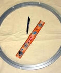 450mm Lazy Susan Aluminum Bearing - Turntable Bearing - 500 lbs next to ruler and pen on beige background