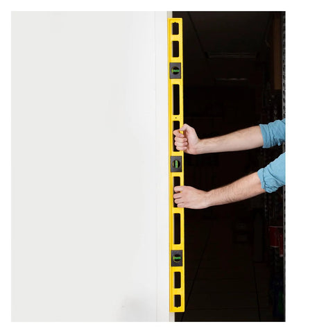 Durable 48 inch polystyrene level with 0.001 inch accuracy, built in the USA, featuring three vials, held against a wall.