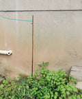 4 Foot Ground Rod With 15 Foot 12 AWG Tinned Copper Ground Wire UL Listed for outdoor setup near wall and greenery