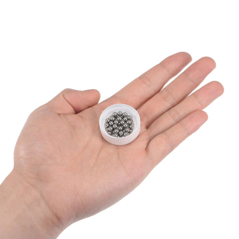 Hand holding a small container of 4mm Stainless Steel Bearing Balls G100 Precision, 304 Stainless, 50 Pack, Smooth Surface, Corrosion Resistant