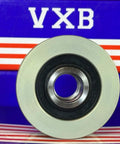 Close-up of silver pulley with black center on VXB packaging