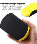 Close-up of a hand holding a yellow 5 Inch Hook And Loop Mouse Sanding Block, showing the hook-and-loop pad for woodworking and furniture.