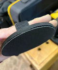 Close-up of 5 Inch Hand Sanding Pad with Hook and Loop Backing for Woodworking and Auto Body, showing EVA holder with strap.