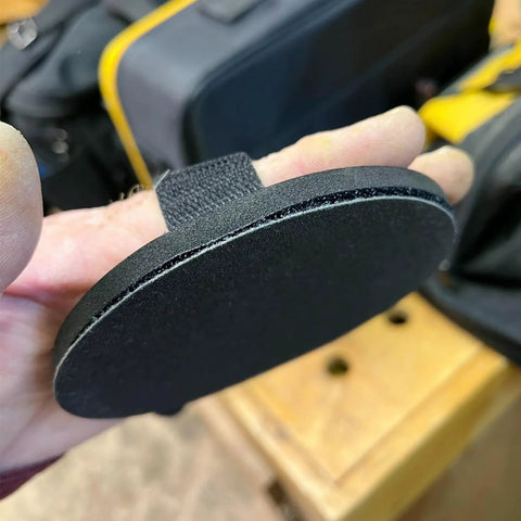 Close-up of 5 Inch Hand Sanding Pad with Hook and Loop Backing for Woodworking and Auto Body, showing EVA holder with strap.