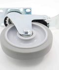 Close-up of a 5 inch swivel caster wheel with dual locking brakes in gray TPR rubber and metal housing, showing the top plate mounting.