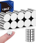 50 Pack Tiny Round Refrigerator Magnets 10x3mm stacked with one magnet on a fingertip, suitable for whiteboards and craft projects.