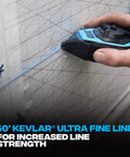 Hand using 50ft Precision Chalk Line Tool Value Pack with Kevlar Ultra Fine Line, 3:1 Gear for accurate line snapping on a wall.