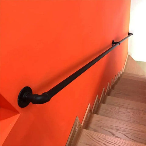 Industrial Water Pipe Stair Handrail Heavy Duty Wrought Iron Banister With Locking Brackets Straightforward Wall Mount for Lofts Attics on orange wall