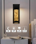 2 Pack Crystal LED Wall Lights With Frosted Matte Shade illuminated beside bed, sleek black aluminum sconce for indoor use, warm glow.