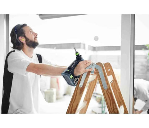 Rugged 18V Cordless Drill With Keyless Chuck And Belt Clip Compact Ergonomic Handle used by man on ladder for fastening tasks.