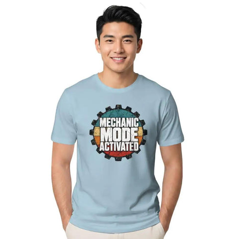 Cool Retro Mechanical Engineer T-Shirt For Real Gearheads And DIY Pros With Vintage Garage Typography Design Perfect For Shop Work Or Casual Days At The Office, worn by a young man, light blue color.