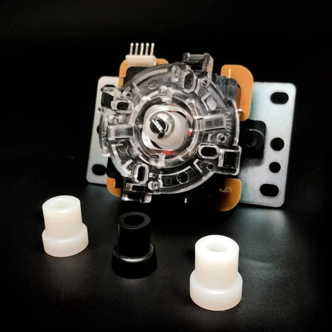 Nylon oversize joystick actuator for Sanwa JLF/Hori Hayabusa; transparent circular housing with metal plate and spacers.