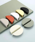 Colorful half-moon drawer pulls displayed on a board, including Green Half Moon Drawer Pulls 2.5 Inch Four Pieces With Screws Semicircle Cabinet Handles.