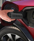 Person using Premium Nacs To J1772 EV Charger Adapter Delivering 80 Amp 19 Kw on electric vehicle charging port.