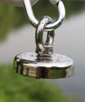 Close-up of shiny Beast 180lb Ultra Strong Fishing Magnet Kit with hook, used for river and outdoor magnetic fishing, 1.89 inch diameter.