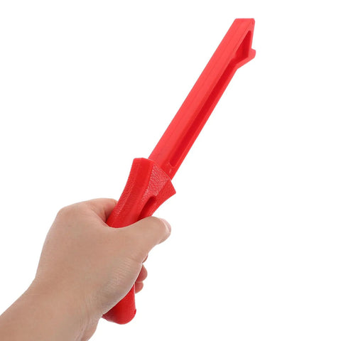 Person holding a red safety push stick for table saw, part of 4 Pack Safety Push Sticks For Table Saw Woodworking Push Blocks Hand Guard For Carpentry Projects Easy Push And Superior Control Durable And Versatile Woodworking Tools For Safer Smoother Cuts And Precision.