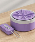 Portable Mini Washing Machine With USB Rechargeable Cordless Setup For Dorm And Travel Featuring Dual Turbine Agitator and Suction Base in purple on wooden surface.