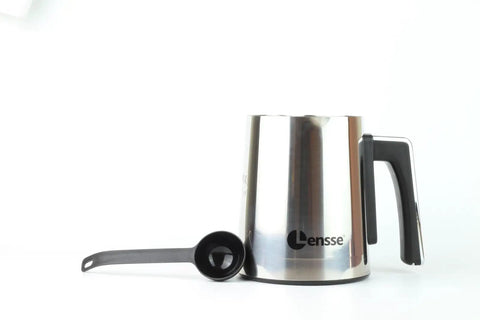 Silver and black Turkish Coffee Maker for 1 to 4 Cups Delivers Consistent Taste and Rich Foam with spoon on white background.
