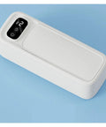 Portable Ultrasonic Cleaner For Jewelry Eyeglasses Retainers And Watches Pink multifunctional gadget on blue background.