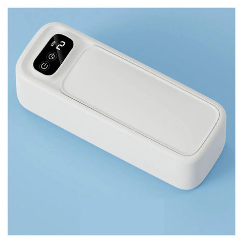 Portable Ultrasonic Cleaner For Jewelry Eyeglasses Retainers And Watches Pink multifunctional gadget on blue background.