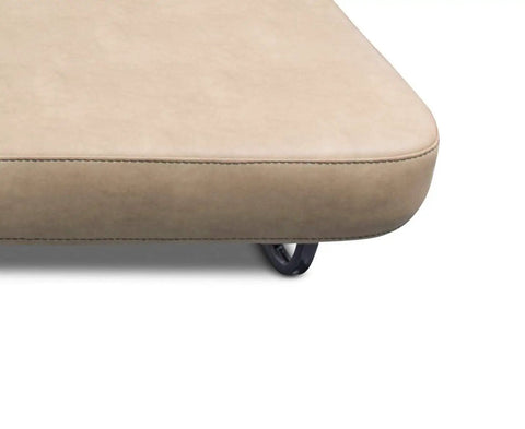 Close-up of beige jackknife sofa edge with view of universal jack knife sofa leg kit in black for Lippert sofas heavy duty 16 gauge steel.