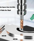 Carbide end mills set, 5 pcs, copper-gold coated bits installed in CNC spindle with spare mill on table