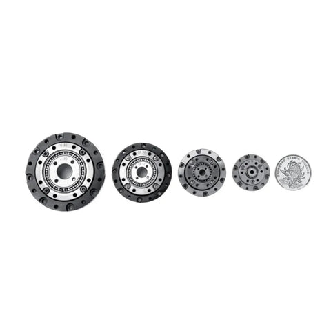 Lineup of High Torque Harmonic Reducer Gearboxes with Strain Wave Gear 50 to 1 Reduction next to a coin for size comparison