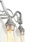 Powell Collection Four-Light Bathroom Vanity Fixture In Classic Nickel Finish with elegant glass shades, close-up view.