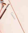Heavy Duty Stainless Steel Cotter Pins With Wavy R Shape Design For Secure Fastening And Anti Loosening Industrial Hitch Applications Precision Made Easy To Install and Remove Every Time No Tools Needed on a pink background.