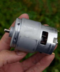 Hand holding RS-755WC-8017 Dc Motor For Power Tools And Drill 12V 24V High Speed High Torque, ideal for drills and saws.