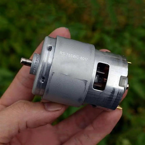 Hand holding RS-755WC-8017 Dc Motor For Power Tools And Drill 12V 24V High Speed High Torque, ideal for drills and saws.