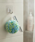 Sick Wall Mount Hooks, Totally Rust Proof Storage Rack for hanging a colorful shower loofah in a bathroom setting.