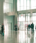 Indoor space showing multiple 2 In 1 LED Exit Sign And Emergency Light Combo With Red Letters High Output Battery Backup