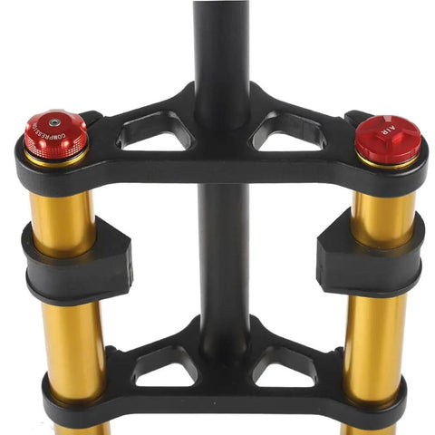 Close-up of black and gold 26 Inch Fat Bike Suspension Fork With 4.0 Inch Tire Clearance, 160mm Travel, double shoulder design.
