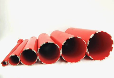 Six red diamond-segmented wet core drill bits in varying diameters.
