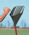 Heavy Duty Garden Rake That Slays Leaves And Debris With Ease Sturdy Tines Do Not Bend Under Pressure Ergonomic red handle shown outdoors