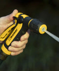 Hand holding Two Pattern Vortex Garden Hose Sprayer Nozzle With Quick Connect Adapter slip resistant grip, jet spray in action