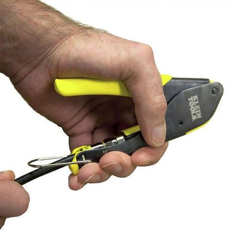 Person using Compact F Connector Compression Crimper for DIY cable installations with fixed plunger, comfort grips, and spring return.