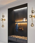 Mid Century Modern Indoor 3 Light Globe Wall Sconce With Smoke Gray Glass Shade And Brushed Brass Finish Vertical Vanity Lamp for Modern Bathrooms Retro Handblown Glass Look Elegant Gold Accents installed in hallway