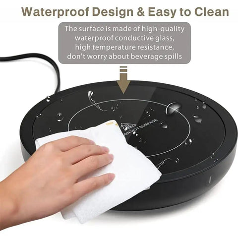 Electric Coffee Mug Warmer With Three Custom Heat Levels And Smart Auto Shut Off Keeps Your Morning Brew Straight Up Toast For Chill Work Days Or Lazy Weekend Routines On Your Workspace Desk In Crisp White Finish, waterproof design shown being wiped clean.
