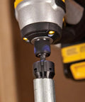 Power Conduit Reamer With Improved Bit Retention reams one inch conduit attached to power drill, shown in use.