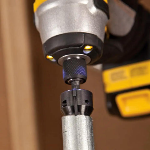 Power Conduit Reamer With Improved Bit Retention reams one inch conduit attached to power drill, shown in use.