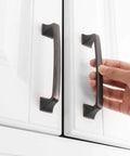 Oil Rubbed Bronze 5 Inch Cabinet Pulls Pack Of 10 Solid Metal Contemporary Big Square Arch Handles being installed on white cabinets.