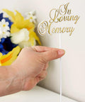 Hand holding Pack Of 36 White Floral Sympathy Picks In Loving Memory With Gold Trim For Memorial Day Funeral Cemetery Florals