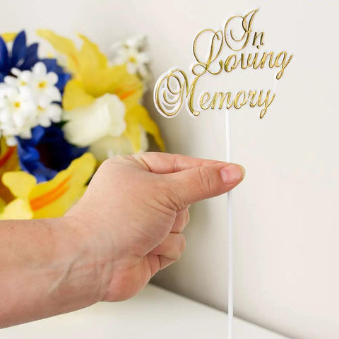 Hand holding Pack Of 36 White Floral Sympathy Picks In Loving Memory With Gold Trim For Memorial Day Funeral Cemetery Florals