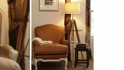 Vintage Teak Wood Tripod Floor Lamp with Chrome Finish 55 Inch Tall Nautical Inspired Rustic Modern Home Decor for Living Room or Den Shade Not Included Durable Steel and Aluminum Construction Unique Gift Idea next to a brown armchair